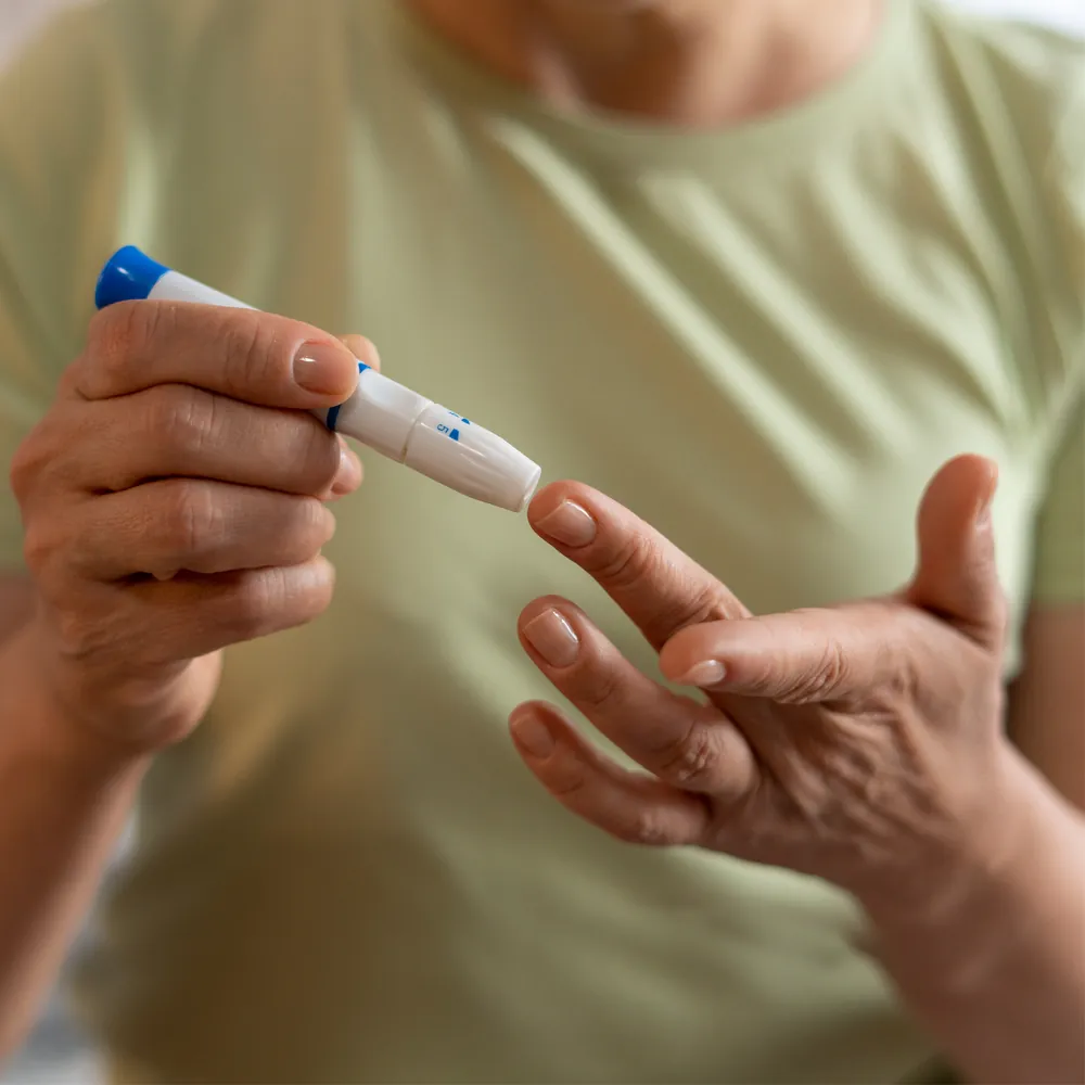 Person checking a fingertip blood glucose result