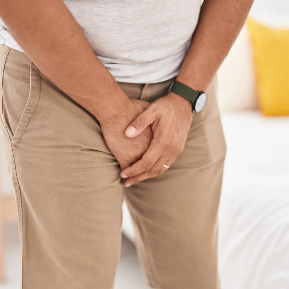 Person holding the groin area during an HPV symptom concept