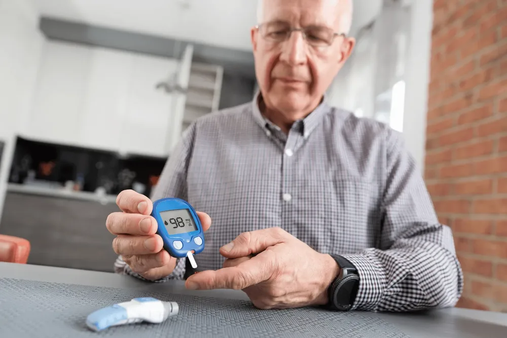 Older man checking his blood glucose meter
