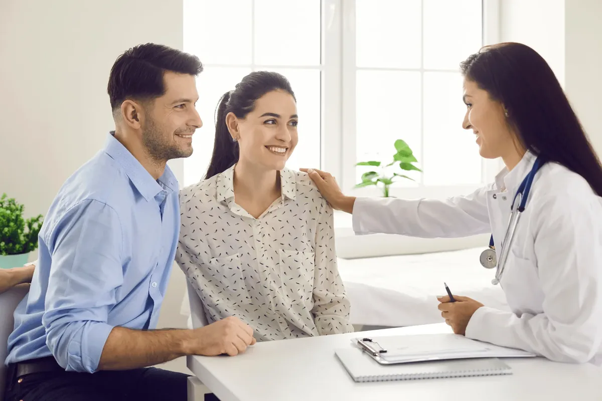 A couple sitting together with a DHA-licensed doctor in Dubai discussing male and female fertility test results