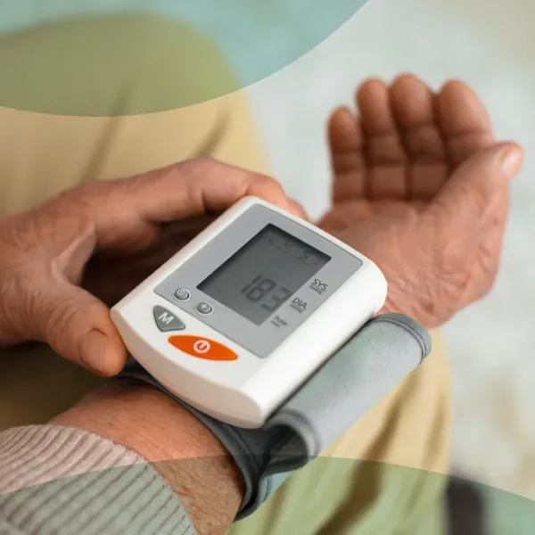 DHA-licensed doctor checking a patient's blood pressure during a diabetes and hypertension home visit in Dubai