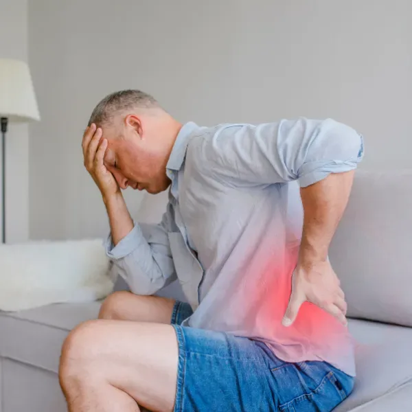 Man with lower back and joint pain treated by home physiotherapy in Dubai