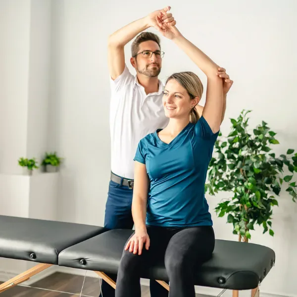 Physiotherapist guiding neurological rehabilitation exercises at home in Dubai