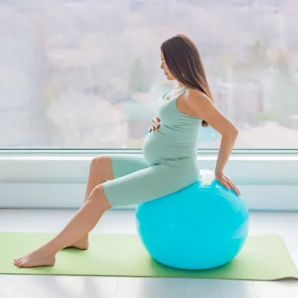 Pregnant woman doing antenatal and postnatal physiotherapy at home in Dubai