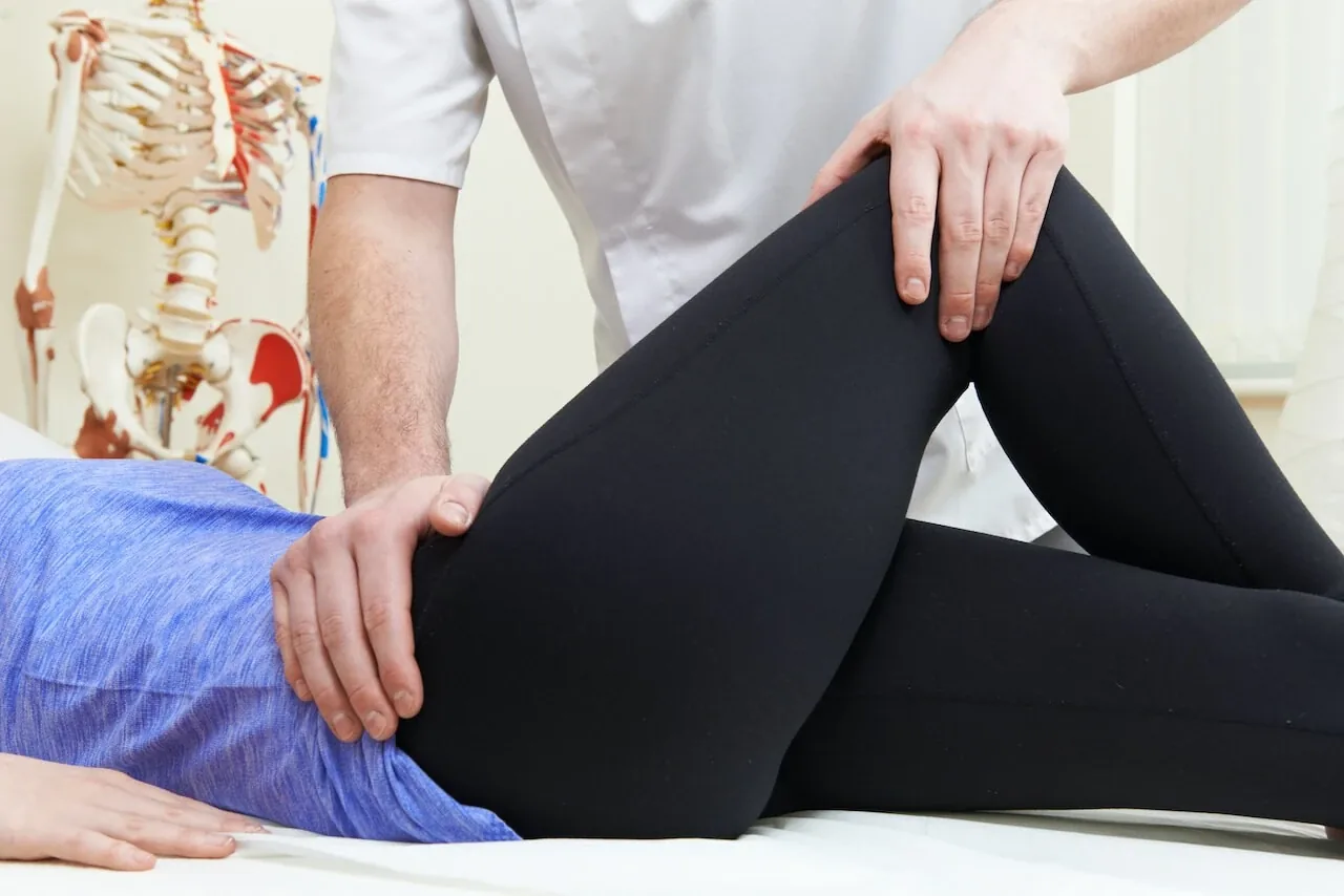 Physiotherapist treating a woman's knee