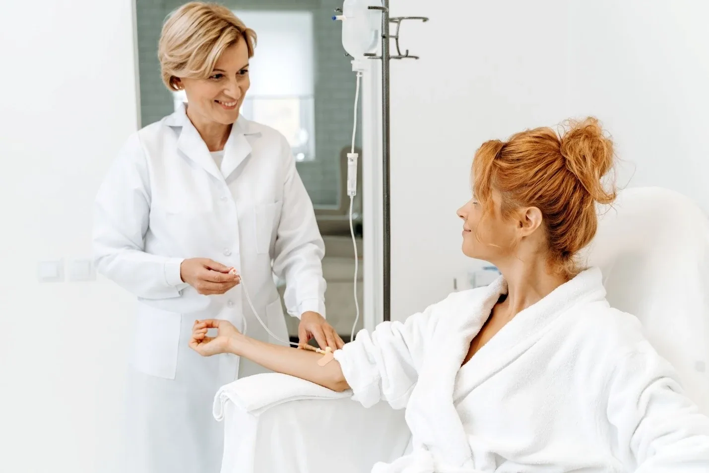 Doctor attending a hotel guest in a bathrobe during a home visit in Dubai