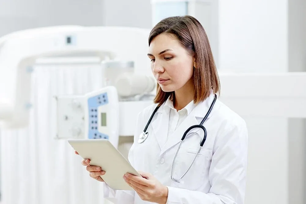 Doctor reviewing medical information on a tablet