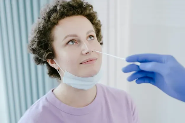 Clinician collecting a nasal swab for a PCR test