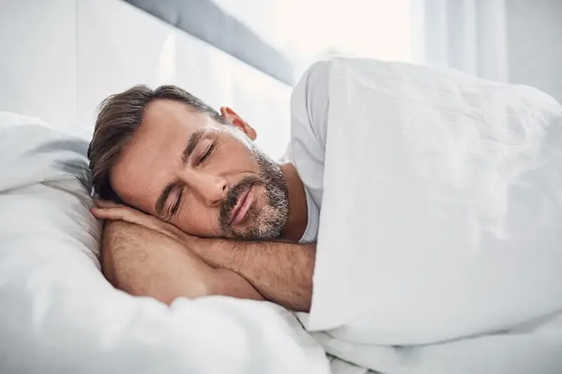 Man sleeping on his side during a sleep apnea concept