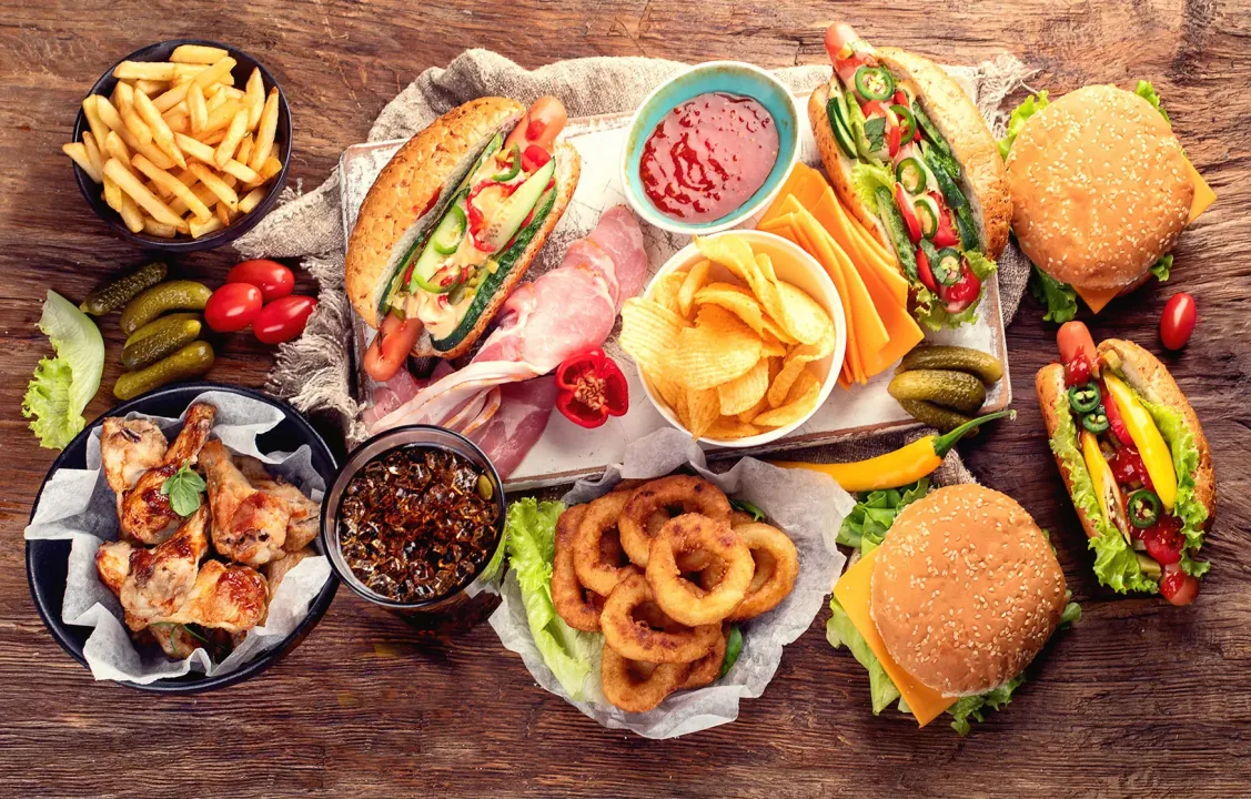 Assortment of fast food burgers, fries and soda illustrating unhealthy eating habits