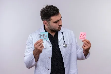 Doctor holding Yes and No cards during a screening decision