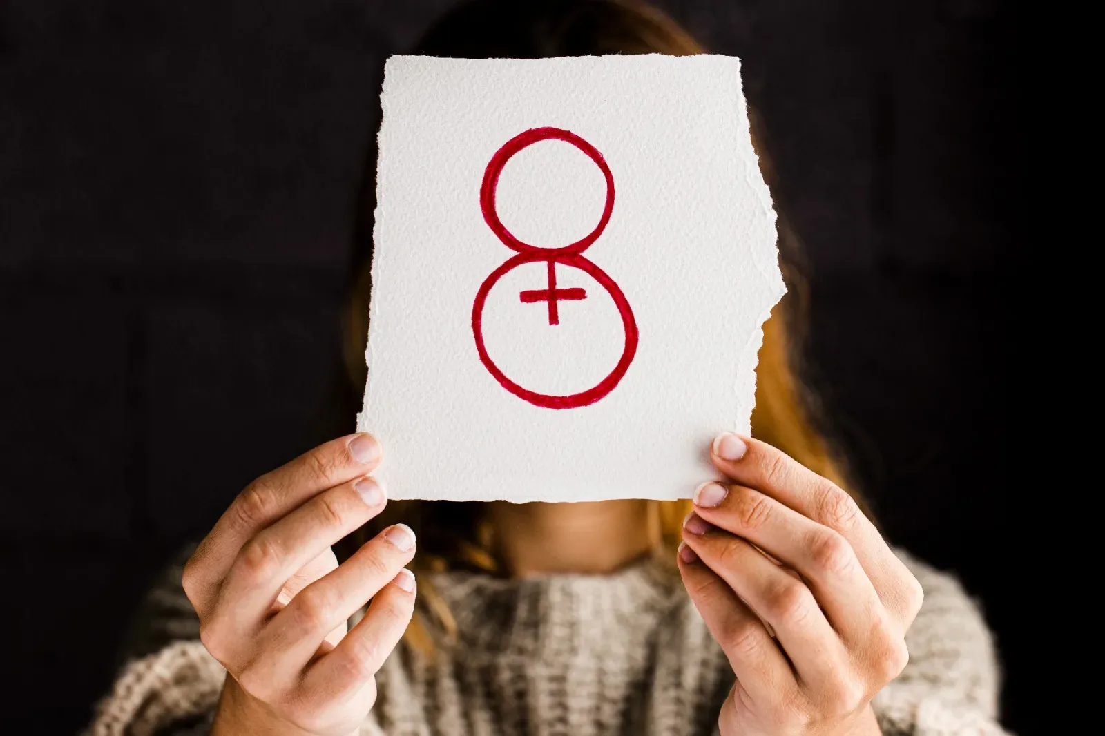 Woman holding a female symbol during a sexual health concept