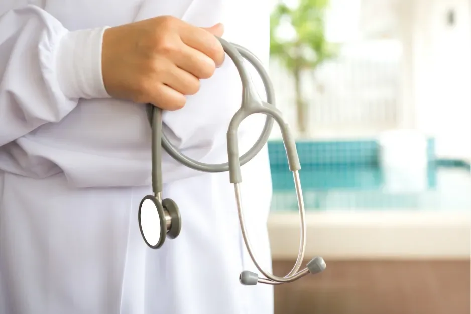 Clinician holding a stethoscope